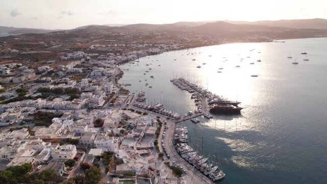 Aerial view of Parikia town and harbor at sunrise on Paros Island Greece with white buildings and blue domes