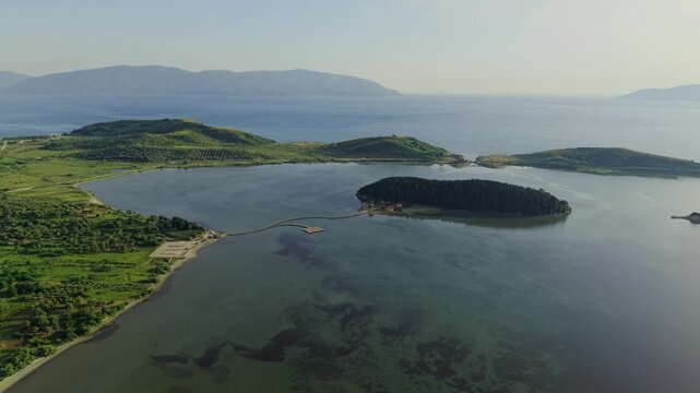 Aerial view of Zvernec Island and the wooden bridge in the Narta Lagoon within the Vjose-Narte Delta Protected Area, Zvernec, Vlore County, Albania.