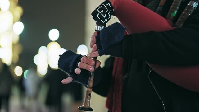 Man Playing Bagpipes on Warsaw Street at Night, Authentic Cultural Scene