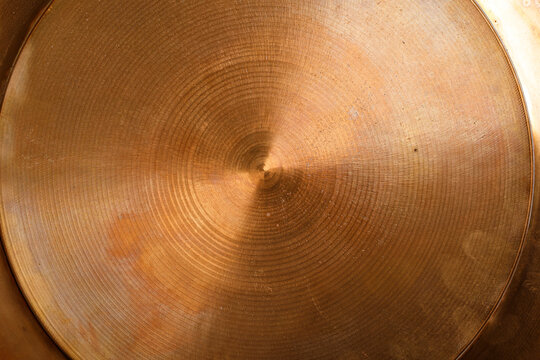 Close up view of aged bronze metal with radiating concentric circles.