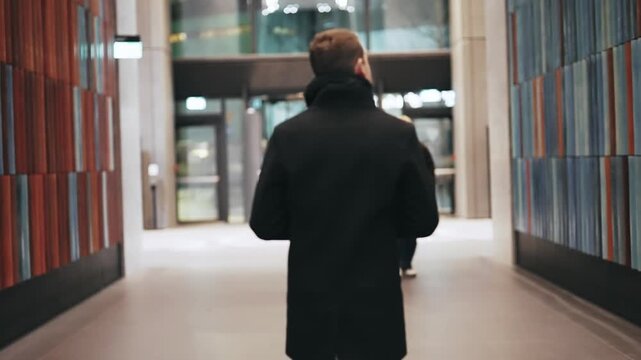 Businessman Walking in Modern Warsaw Corridor at Office Building