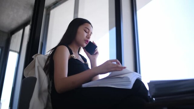 Woman working writing notes in notebook while using a laptop represents business education and professional development concepts of remote work studying and productivity.