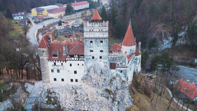 Aerial panoramic of historic Bran Castle, a medieval fortress in Romania.