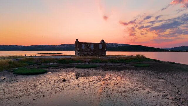 Cinematic Aerial Drone Reveal of Ancient Bargylia Ruins at Golden Hour Sunset, Stone Building Reflection in Lagoon, Aegean Coast, Bogazici Milas Mugla Turkey
