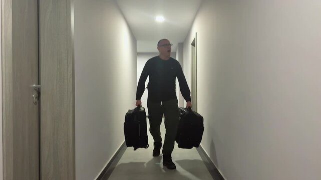 Man Carrying Suitcases in Eerie Hallway with Blinking Light Effect