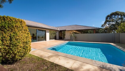 Fototapeta premium rear garden of a contemporary australian home with tiled swimming pool modern real estate high quality photo