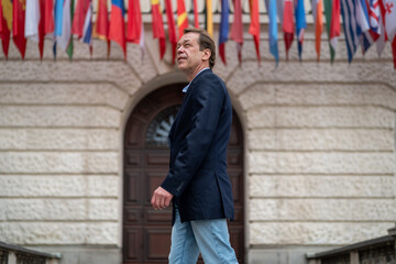 Fototapeta premium Businessman Looking Up Against International Flags