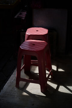 Red Plastic Stools Illuminated by Morning Light