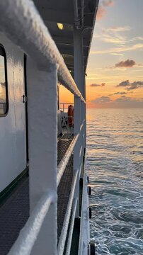 Sunset View from Cruise Ship Deck Walkway Overlooking Calm Ocean