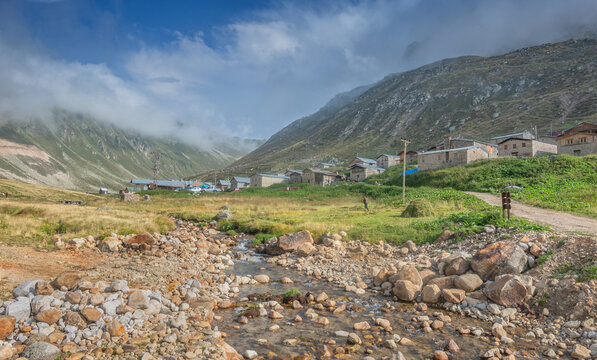 Traditional stone and wooden houses of Trovit Highland under foggy peaks in Kackar Mountains, Rize, Turkey