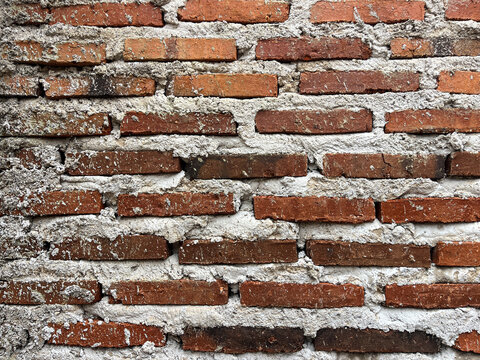 Close-up of red brick wall texture with visible mortar joints, ideal as a construction, architecture, or rustic background