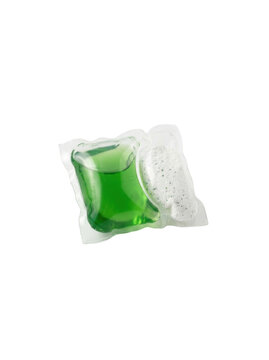A green laundry detergent pod in a clear plastic package on a white background.