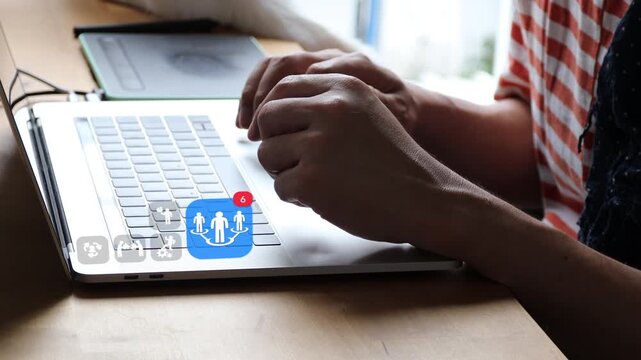Close up of casual Asian man using laptop computer at home, showing 3D tracked human resources connection badge with corporate puzzle and pie chart icons.
