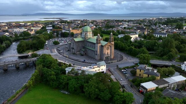 Galway drone shot at sunset, famous Galway cathedral and Salmon Weir bridge and Dam aerial view, travel and tourism in Ireland, Irish city on the Atlantic coast