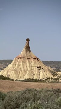 Bardenas Reales in Navarre, Spain. Erosion-sculpted landform in Bardenas Reales, Navarre, Spain. Characterized by a conical shape with a flat top composed of a harder rock layer above softer clay 