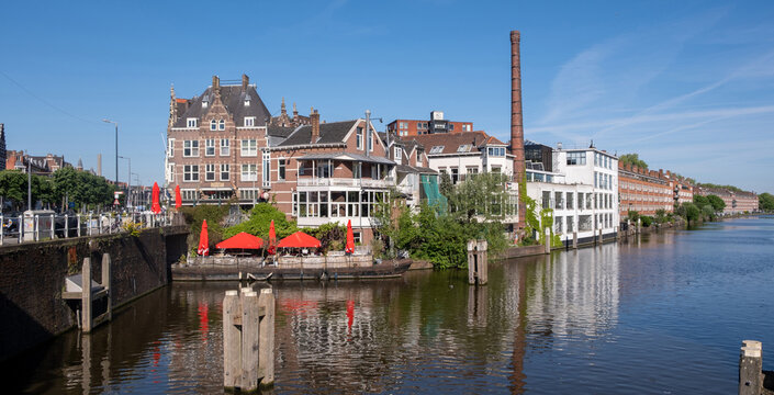 Historic canal waterfront and brick architecture in Delfshaven Rotterdam on sunny spring day