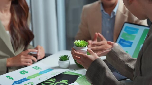 Professional team meeting in a conference room, collaborating on a sustainable business model and green corporate strategy focused on environmental, social, and governance principles for growth