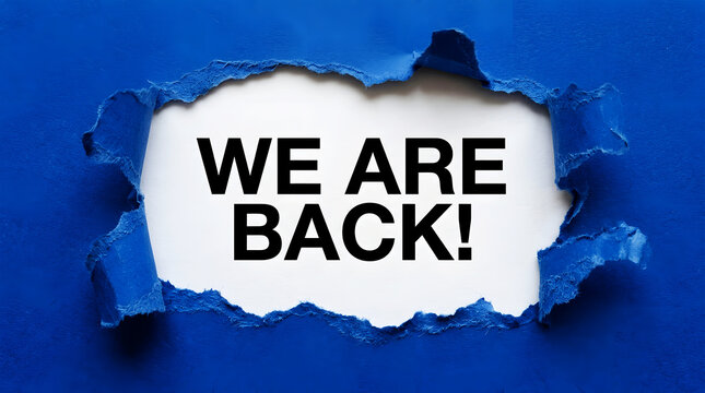 Blue paper torn open revealing black text saying We Are Back ripped opening