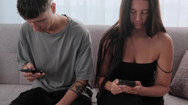 Phubbing in relationship, couple focused on smartphones instead of each other, social media distraction and loss of real connection