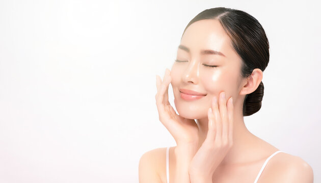 Smiling Asian woman touching her face with both hands 両手で顔に触れて微笑むアジア人女性