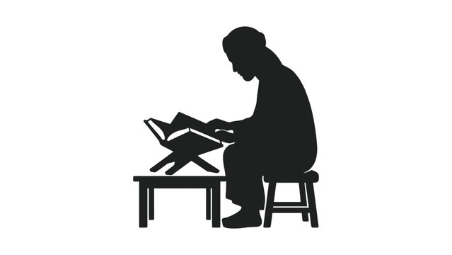 Silhouette of a man sitting and reading a holy book on a wooden stand.