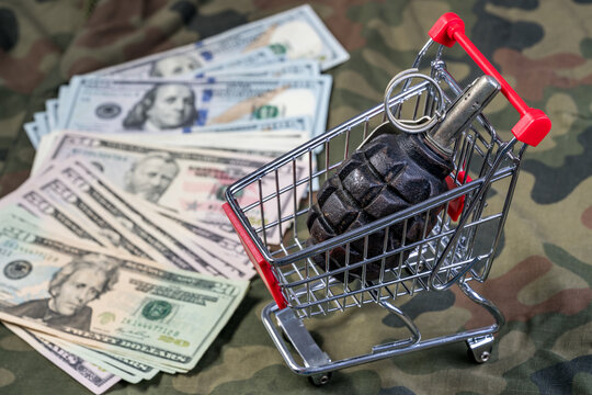 A grenade in a shopping cart on Polish uniform camouflage background with US Dollar banknotes
