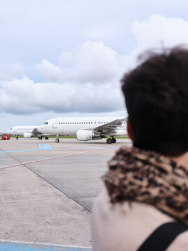 Traveler watching airplanes parked on airport tarmac in Bucharest