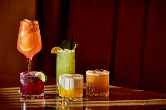 Assorted Craft Cocktails in Moody Lounge With Warm Ambient Lighting