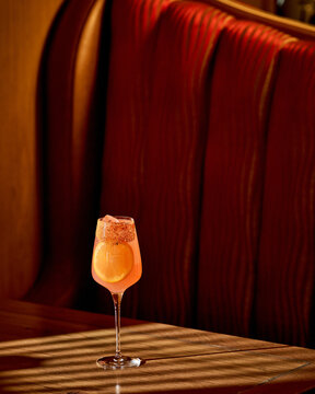 Elegant Sparkling Cocktail in Luxury Lounge Booth With Moody Lighting