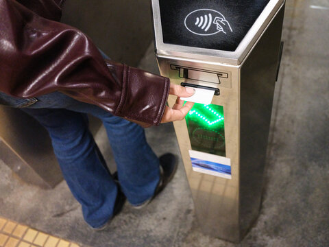 Person validating ticket at Bucharest metro turnstile