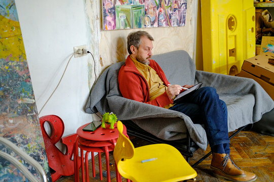 Male designer working on tablet in creative studio workspace