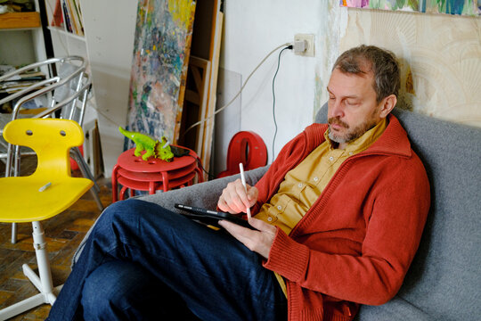 Male designer working on tablet in creative studio workspace