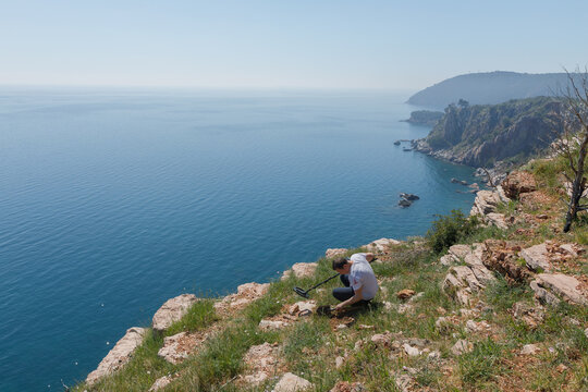 Man digging up the supposed location of a valuable find 