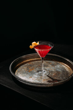Red cocktail on vintage tray