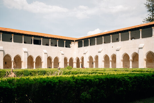 Historic Courtyard in a Building With Arches and Greenery