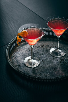 two ed cocktails in martini glass with  lemon garnish