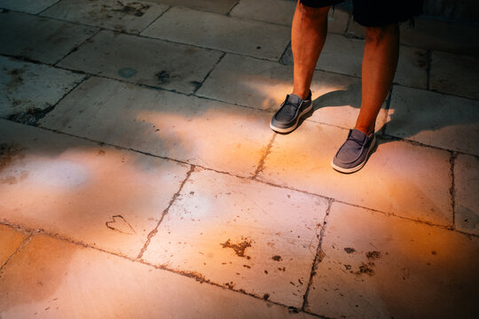 Shoes on the Floor With Light Patterns at an Indoor Location