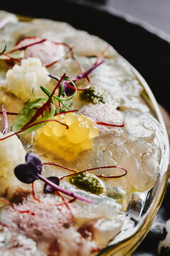fine dining white fish fillet with yellow jelly balls 