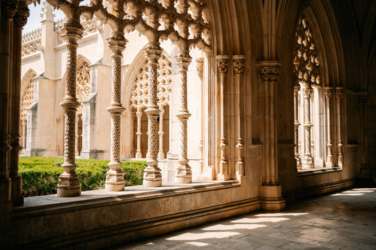 Exploring a Historic Cloister With Intricate Stonework and Sunlight