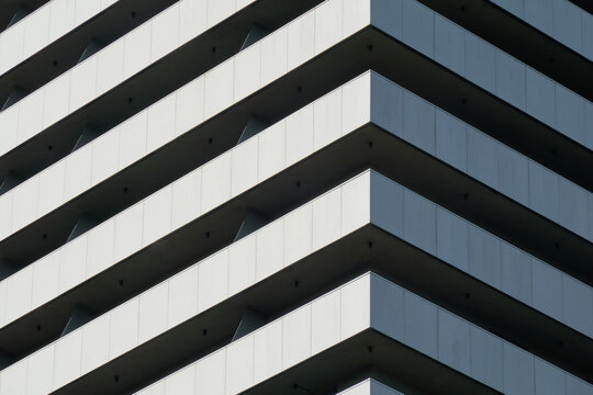 Geometric facade of modern building with balcony
