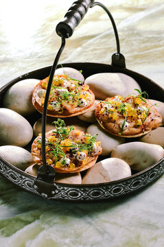 Crispy flatbread with yellow citrus balls and garnish 
