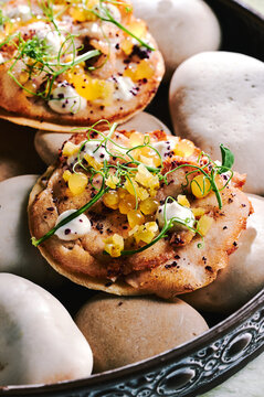 fine dining small round flatbread served on river stones 