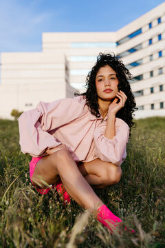 Woman crouching in grass 