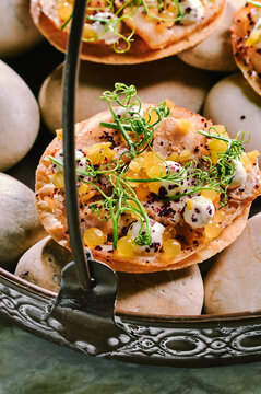 Round flatbread with meet served on river stones 