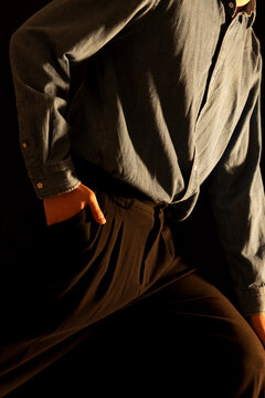 Azure blue shirt and black slacks with warm orange light