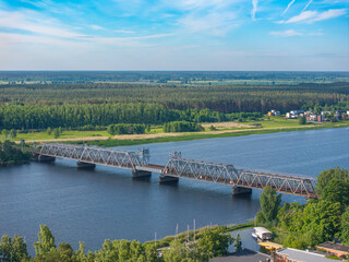 Obraz premium Aerial view of the Lielupe railway bridge over the Lielupe River in Jurmala, Latvia