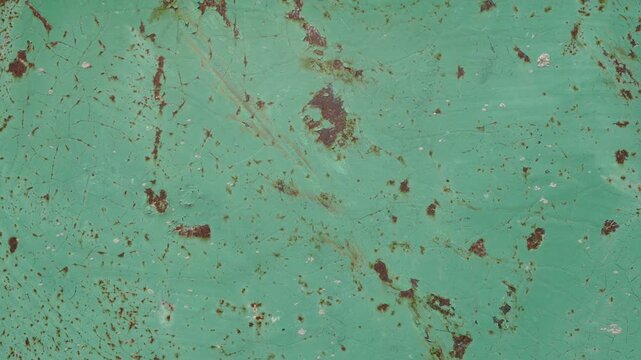 Close-up of weathered rusty painted metal surface with scratches and worn paint texture