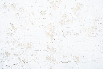 Fototapeta premium White cracked plaster wall texture with peeling paint, distressed concrete background, subtle beige stains, grunge surface for design backdrop.