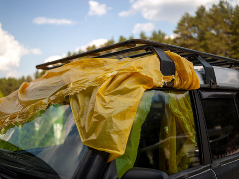 car top and windshield covered with plastic