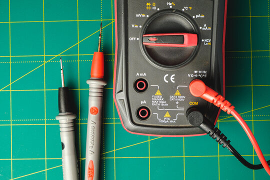 Exploring electronics with a digital multimeter on a vibrant workbench